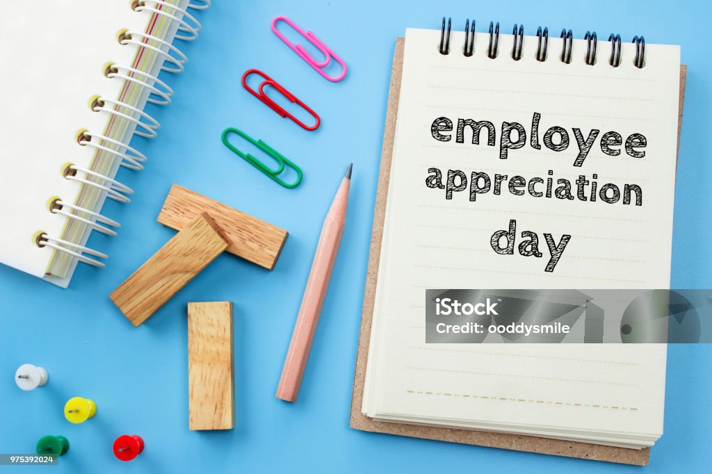 Text Employee appreciation day on white paper book and office supplies on blue desk / business concept Employee Appreciation Day Stock Photo