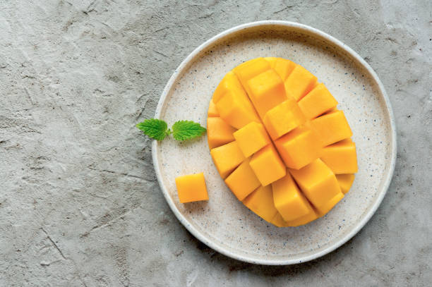 Sliced mango fruit on plate. stock photo