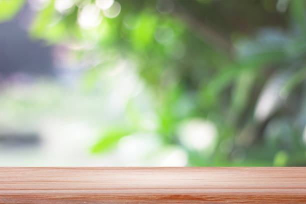 istock empty wooden on blurred nature backdrop. Wood table top. can used for display or montage your products 975445414