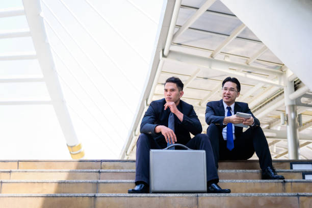 istock Two asian businessman has talking and looking for business vision. 975446192