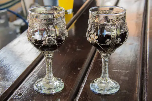 Two glasses. Pour red wine. Ruby color. Magical taste. Glasses are decorated with silver. Handmade.