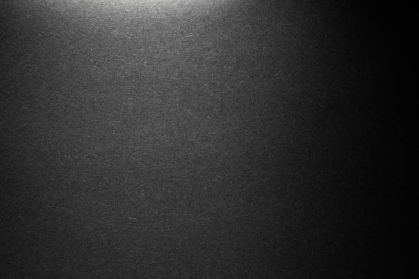 istock black paper texture or background with spotlight, dark wall backdrop wallpaper, dark tone. 975462558