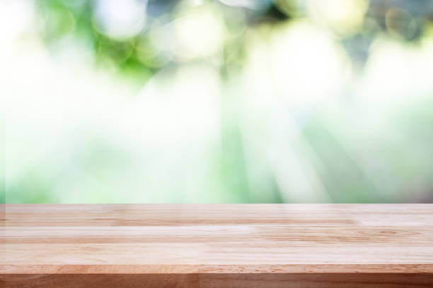istock empty wooden on blurred nature backdrop. Wood table top. can used for display or montage your products 975462764