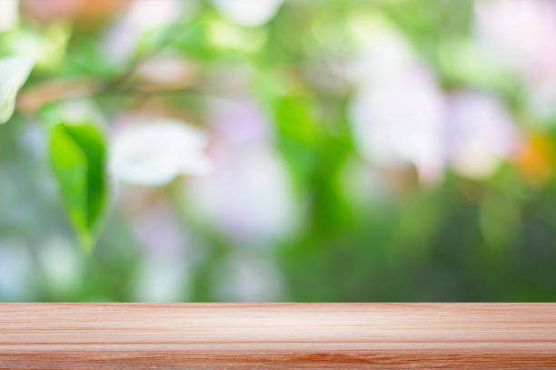 istock empty wooden on blurred nature backdrop. Wood table top. can used for display or montage your products 975467994