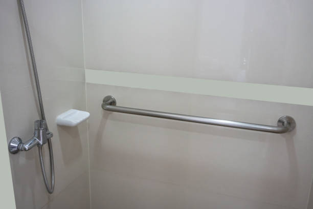 Bathroom interior in patient room with basic required equipment. Modern design in beige color.