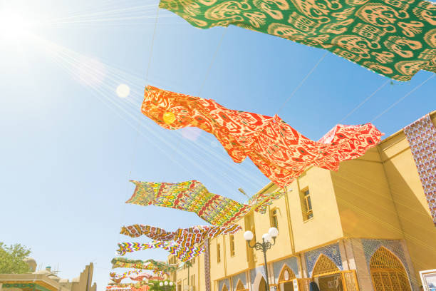 Waving in sky fabric. Silk textile fabric materials fluttering against the blue sky with brightly shining sun light.