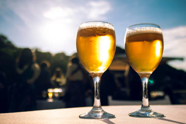 istock Two bright blond beers close up on an outdoor summer party 975521784