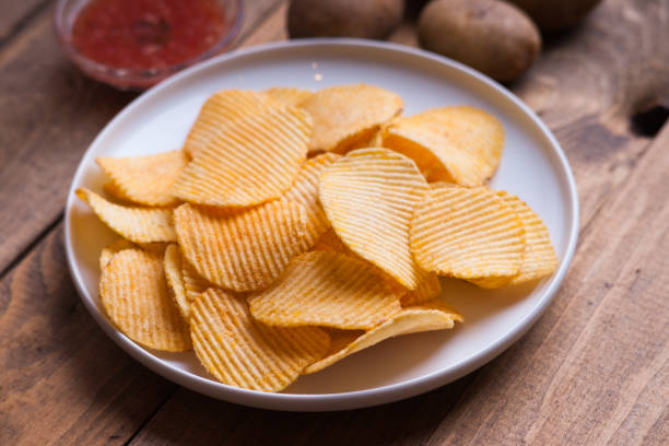 istock Crispy potato chips, potato and sauce 975581220