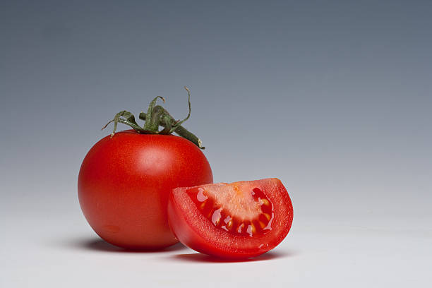 Tomato whole and sliced stock photo