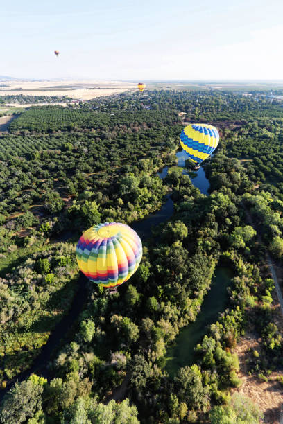 istock Hot -air balloons over a creek 975586970