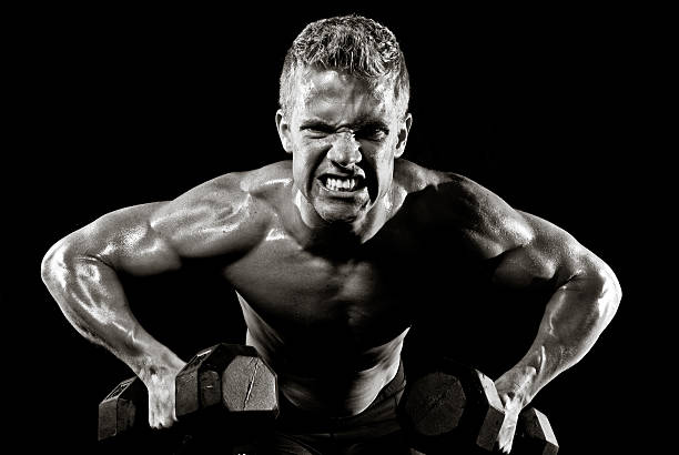 Male Fitness Model Lifting Dumbbells stock photo