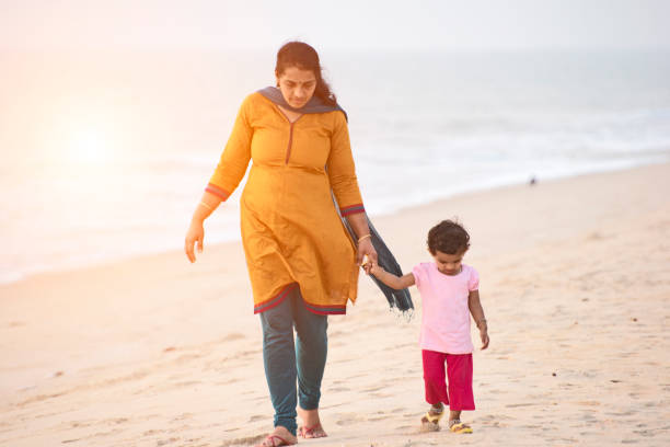 istock mother and daughter in beach 975593442