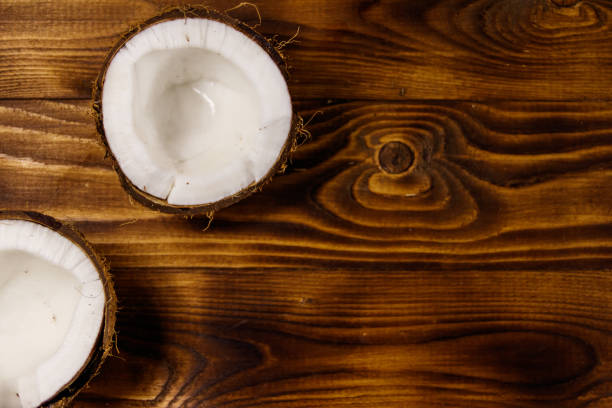 istock Fresh ripe coconut on rustic wooden table 975595952
