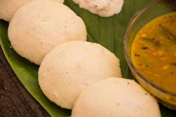 istock idli with coconut chutney and sambhar bowl placed on green leaf 975602230