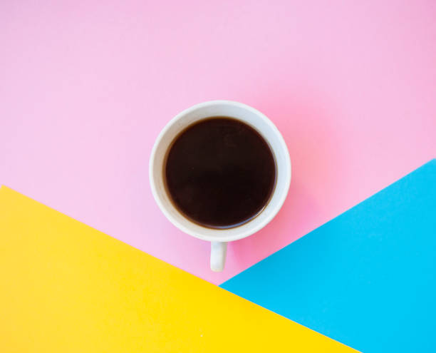 istock A cup of coffee on colorful background. 975602570