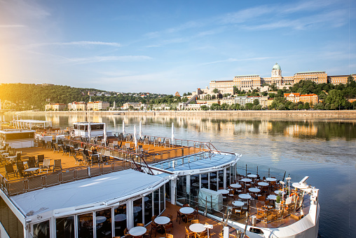 Cityscape view on Buda riverside with restaurant ship on Danube river in Budapest city, Hungary