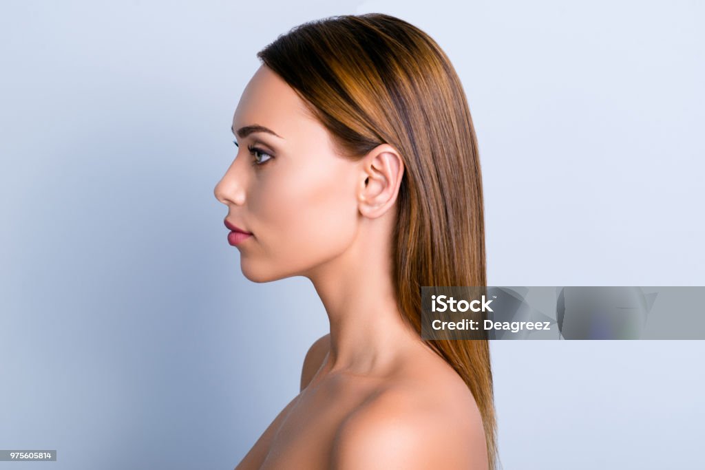 Trend dermatology purity medicine lotion ear rhinoplasty nose wellness concept. Profile portrait of beautiful woman with ideal smooth nourished hairdo isolated gray background In Silhouette Stock Photo