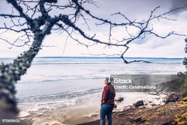 Young Woman Enjoying Relaxing And Observing The View Of Lake Stock Photo - Download Image Now
