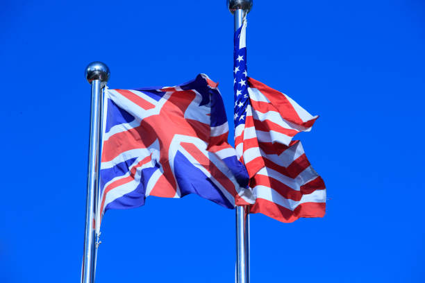 istock Union Jack  &  American Flag  in the Wind 975608588