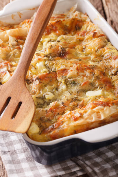 istock Balkan food: Serbian pie Gibanica with cheese, eggs and greens close-up. vertical 975609028