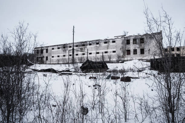 istock Exterior of old decayed abandoned prison in Kolyma in evening light 975611696