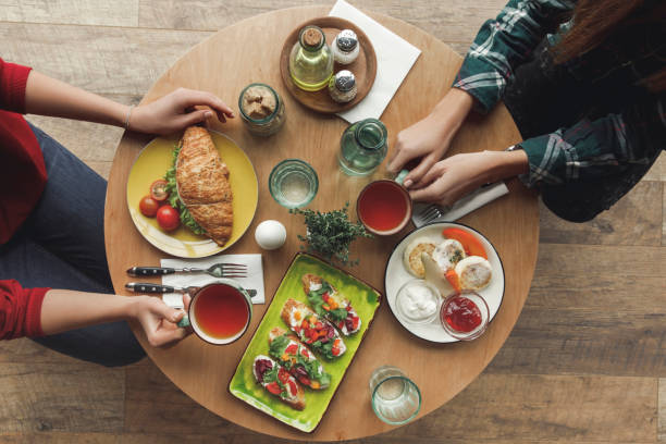 istock top view of people drinking tea and having breakfast together 975611838