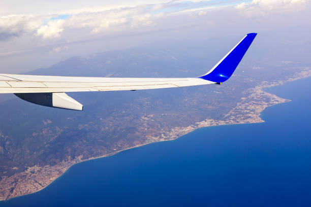 Wing of an airplane with the city of Ayvalik, Turkey