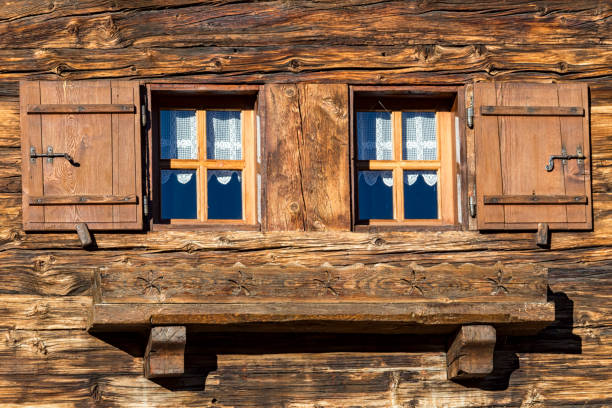 Typical facade of an alpine chalet made with wood