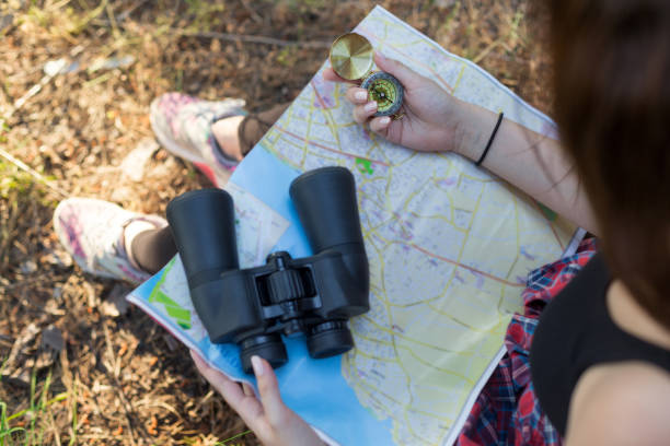 istock Two girls hiking in forest and using compass 975628764