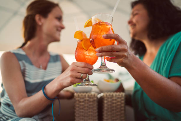 Friends drinking cocktails on beach holiday