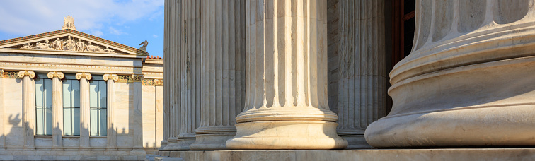 The Ionic order forms, classical architecture background with false column capital over stone wall. Bath, United Kingdom