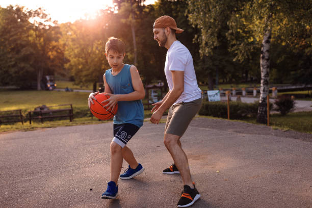 istock Father and son playing basketball 975632064