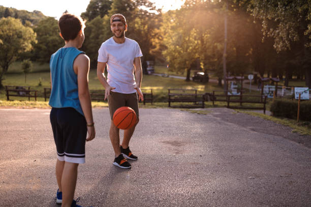 istock Father and son playing basketball 975632118