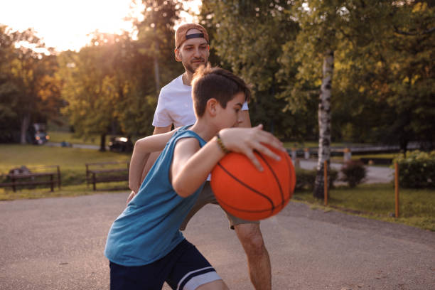 istock Father and son playing basketball 975632540