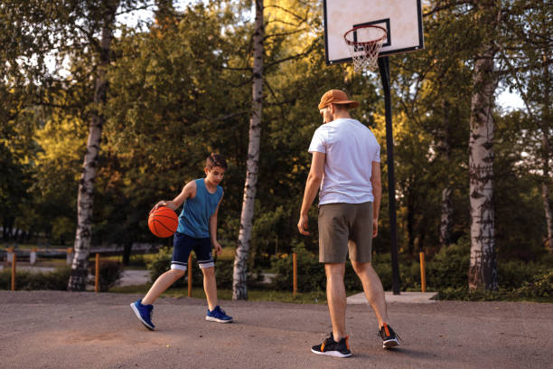 istock Father and son playing basketball 975632628