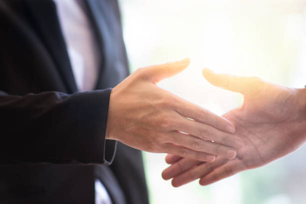 istock shaking hands during a meeting in the office, success, dealing, greeting and partner concept 975643174