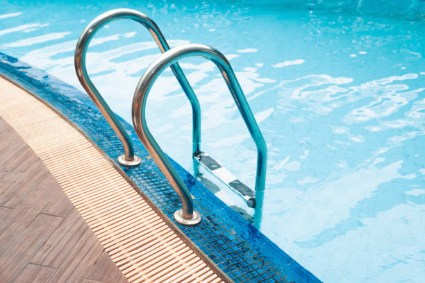 istock Swimming pool and grab bar ladder 975653188