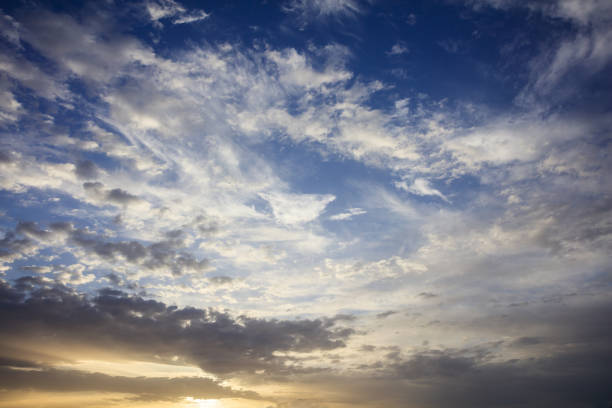 Few clouds on a blue sky background at sunset