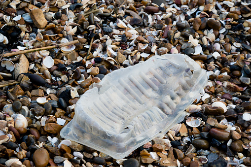 Plastic litter and other rubbish left on the beach on the Isle of Grain, Kent, United Kingdom