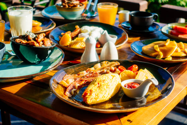 istock Healthy breakfast set with egg bacon pancakes orange juice milk bread and coffee 975667038