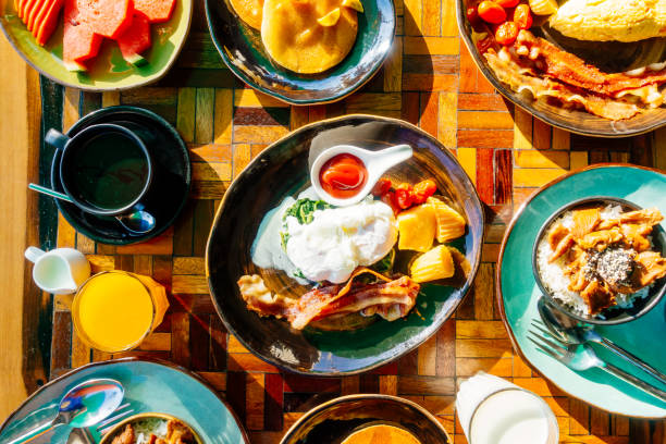 istock Healthy breakfast set with egg bacon pancakes orange juice milk bread and coffee 975670492