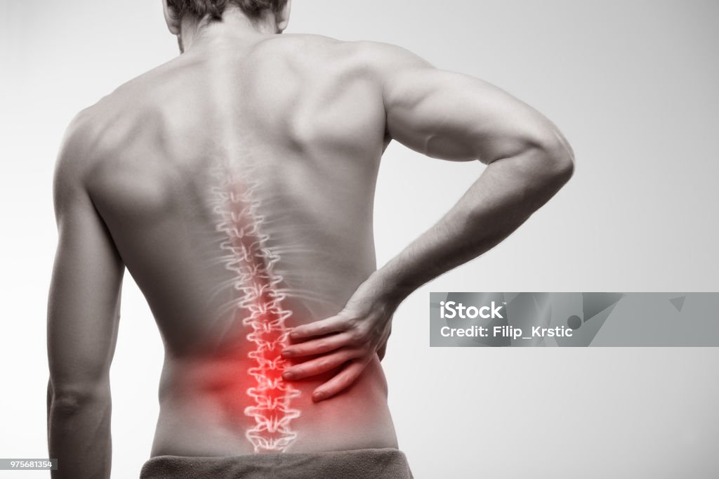 Lower back pain. Male torso seen from behind. Backache Stock Photo