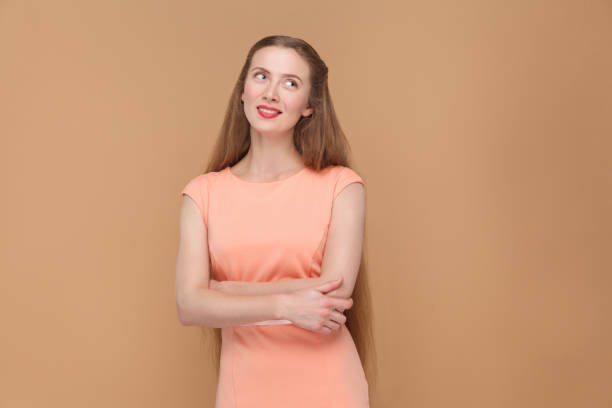 istock pondering, dreaming beautiful woman looking away. 975689082