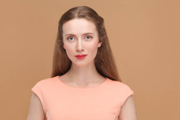 istock blue eyes woman with red lips and smiley face looking at camera. 975689086