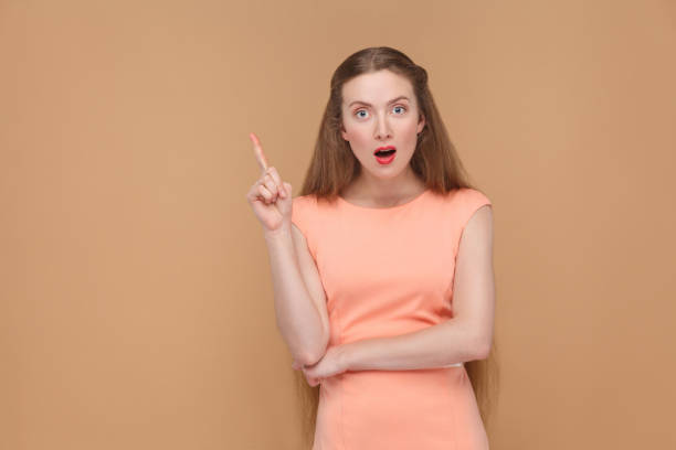istock oh i have an idea. amazed woman looking at camera. 975689206