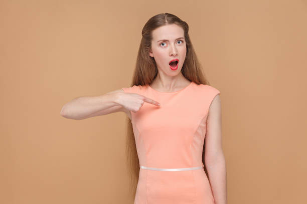 istock Is that me? surprised woman looking at camera. 975689214