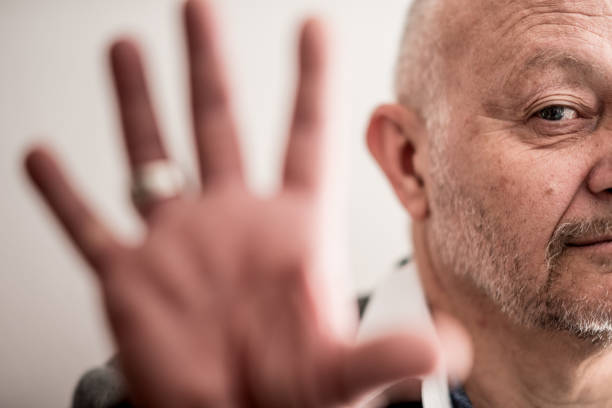 Senior Man Showing Opened Fist to Camera.