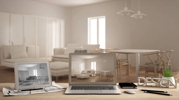 istock Architect designer concept, laptop and tablet on wooden work desk with screen showing interior design project and CAD sketch, blurred draft in the background, living room idea 975698776