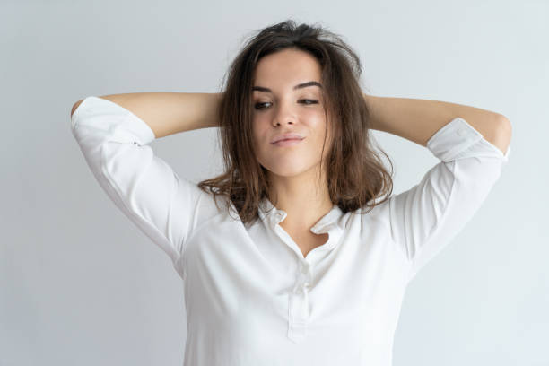 istock Arrogant girl setting hair and smirking. 975699008