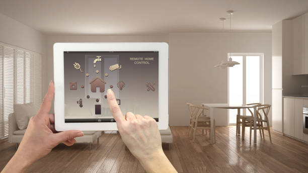 istock Smart remote home control system on a digital tablet. Device with app icons. Minimalist modern bright living room in the background, architecture interior design 975699034